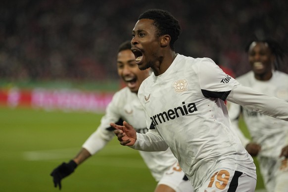 Leverkusen&#039;s Nathan Tella , right, celebrates after scoring the opening goal during a German Cup round of 16 soccer match between Bayern Munich and Bayer Leverkusen at the Allianz Arena in Munich ...
