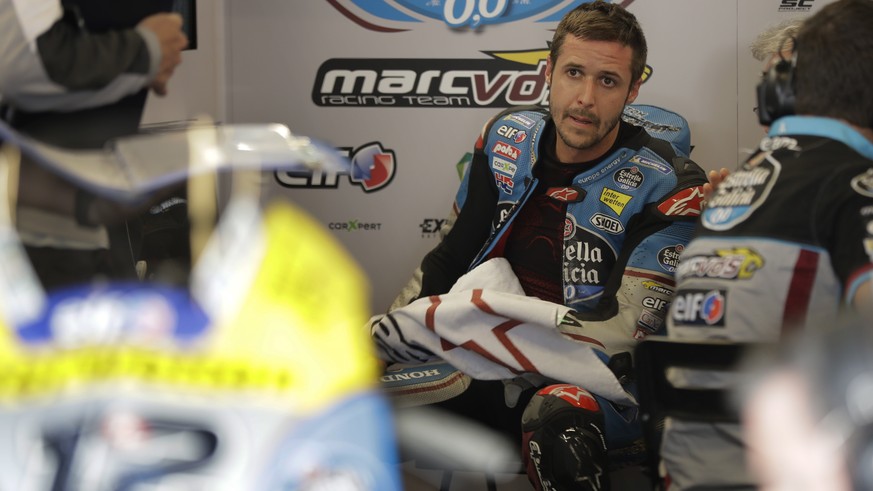 Thomas Luthi (12) of Switzerland talks with a team member in the garage area during a warm up session for the Grand Prix of the Americas motorcycle race at the Circuit Of The Americas in Austin, Texas ...