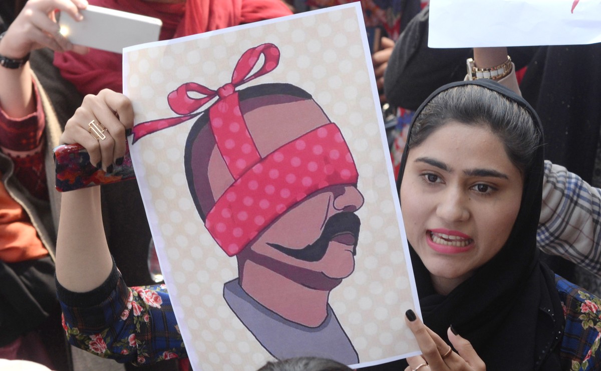 epa07403435 People hold depection of captured Indian Air Force Pilot Wing Commander Abhinandan, as they shout anti-India slogans during a protest in Lahore, Pakistan, 28 February 2019. Pakistan's ...