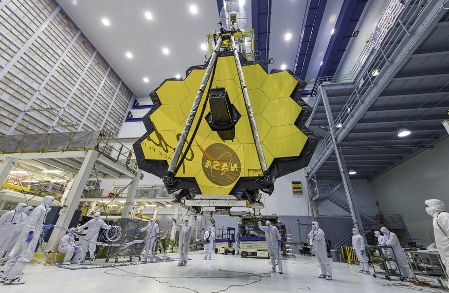 FILE - In this April 13, 2017 photo provided by NASA, technicians lift the mirror of the James Webb Space Telescope using a crane at the Goddard Space Flight Center in Greenbelt, Md. NASA announced Tu ...