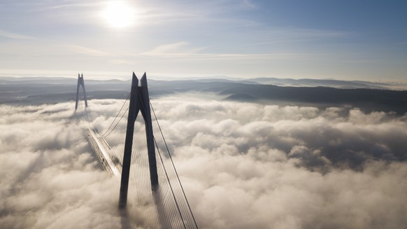 epa08116200 An aerial picture taken by drone shows Yavuz Sultan Selim Bridge under heavy fog at the Bosphorus in Istanbul, Turkey 10 January 2020. Due to heavy fog Bosphorus closed to transit ships on ...