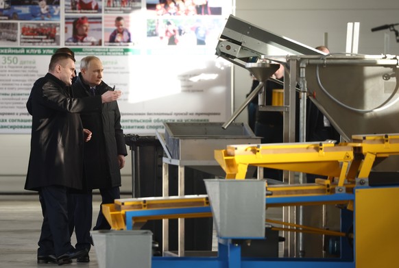 epa10459232 Russian President Vladimir Putin (R), accompanied by ULK Group CEO Vladimir Butorin, visits the Ustianskiy timber complex in Arkhangelsk region, Russia, 10 February 2023. Putin held meetin ...