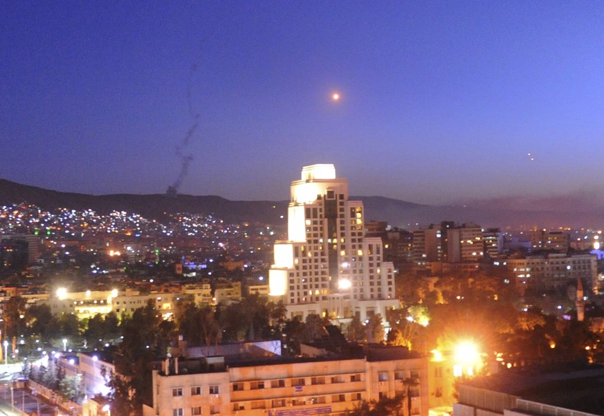 This photo released by the Syrian official news agency SANA, shows smoke, rising after U.S.-led airstrikes targeting different parts of the Syrian capital Damascus in retaliation for the country&#039; ...