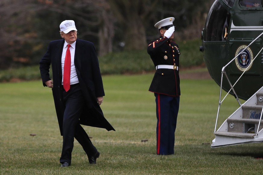 President Donald Trump walks on the South Lawn as he returns back to the White House in Washington, Friday, Dec. 15, 2017, from a trip to Quantico, Va. (AP Photo/Manuel Balce Ceneta)