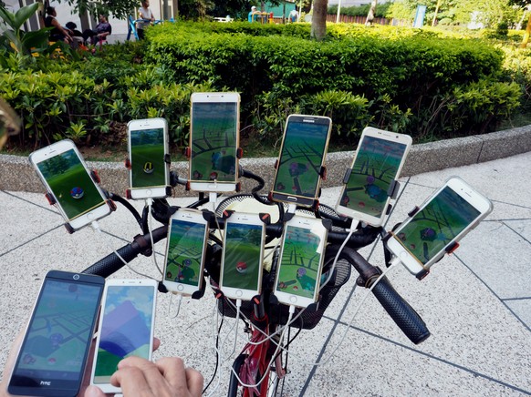 epa06935291 Chen San-yuan (Not Seen in Picture), a 59-year-old Feng Shui Master, used 11 cellphones to catch Pokemon in a park in New Taipei City, Taiwan, 08 August 2018. Chen was hooked on Pokemon Go ...