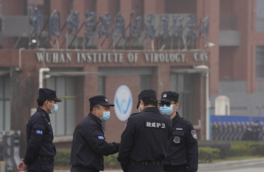 Security personnel gather near the entrance of the Wuhan Institute of Virology during a visit by the World Health Organization team in Wuhan in China&#039;s Hubei province on Wednesday, Feb. 3, 2021.  ...