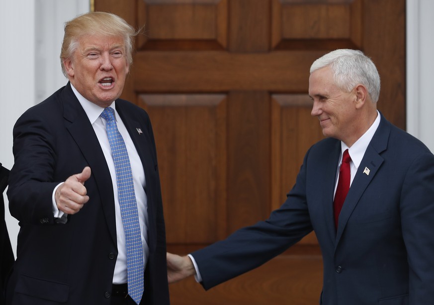 President-elect Donald Trump, left, calls out to media as he and Vice President-elect Mike Pence appear at the Trump National Golf Club Bedminster clubhouse, Sunday, Nov. 20, 2016, in Bedminster, N.J. ...