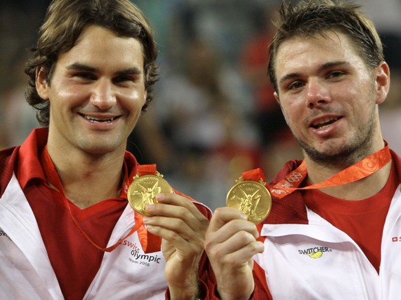 FILE- In this Saturday, Aug. 16, 2008, file photo, Roger Federer, left, and Stanislas Wawrinka of Switzerland celebrate winning the men's tennis doubles gold medal at the Beijing 2008 Olympics in ...