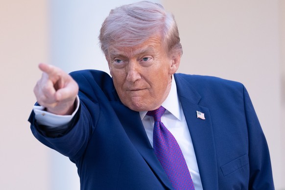 epa12948634 US President Donald Trump gestures during a law enforcement leaders dinner, celebrating the start of National Police Week, in the Rose Garden of the White House in Washington, DC, USA, 11  ...