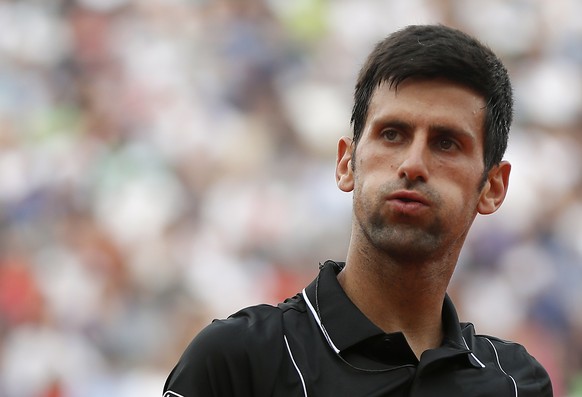 epa06787053 Novak Djokovic of Serbia reacts as he plays Marco Cecchinato of Italy during their menâs quarter final match during the French Open tennis tournament at Roland Garros in Paris, France, 0 ...