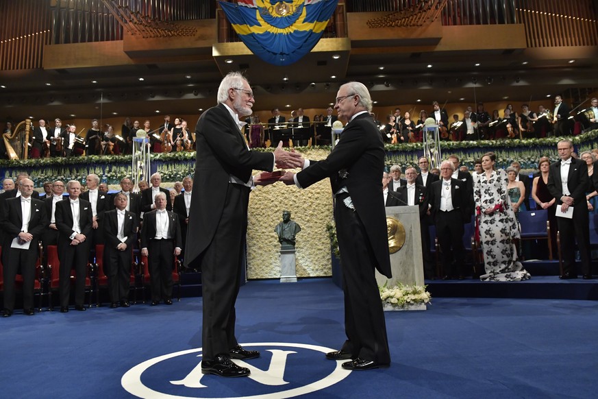 epa06381598 Jacques Dubochet, laureate in Chemistry, receives his Nobel Prize by King Carl Gustaf of Sweden during the Nobel award ceremony in the Concert House in Stockholm, Sweden, 10 December 2017. ...