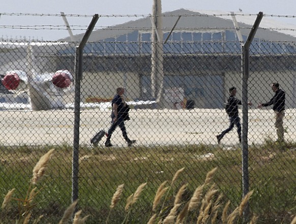 Passengers and crew leave the hijacked Egyptair Airbus A320 at Larnaca Airport in Larnaca, Cyprus, March 29, 2016 REUTERS/Yiannis Kourtoglou