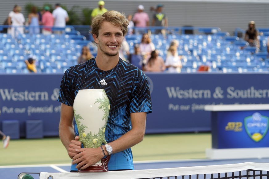 Alexander Zverev, of Germany, holds the trophy after defeating Andrey Rublev, of Russia, in the men&#039;s single final of the Western &amp; Southern Open tennis tournament, Sunday, Aug. 22, 2021, in  ...