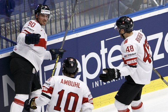Switzerland's Roman Josi, left, celebrates his goal with teammates Andres Ambuehl, center, and Matthias Bieber, right, after scored the 0:1, during the IIHF 2015 World Championship quarterfinal game USA vs Switzerland, at the CEZ Arena, in Ostrava, Czech Republic, Thursday, May 14, 2015. (KEYSTONE/Salvatore Di Nolfi)
