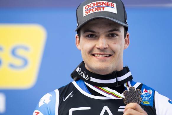 epa09016646 Loic Meillard of Switzerland celebrates the Bronze medal for Parallel race during the medals ceremony at the 2021 FIS Alpine Skiing World Championships in Cortina d&#039;Ampezzo, Italy, 15 ...