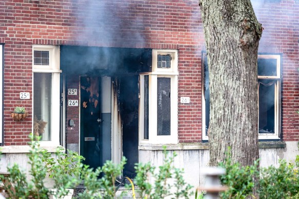 epa10888202 Fire in a building on the Heiman Dullaertplein in Rotterdam, the Netherlands, September 28, 2023. Two shooting incidents took place in Rotterdam in which two people were injured: at a house on the Heiman ...