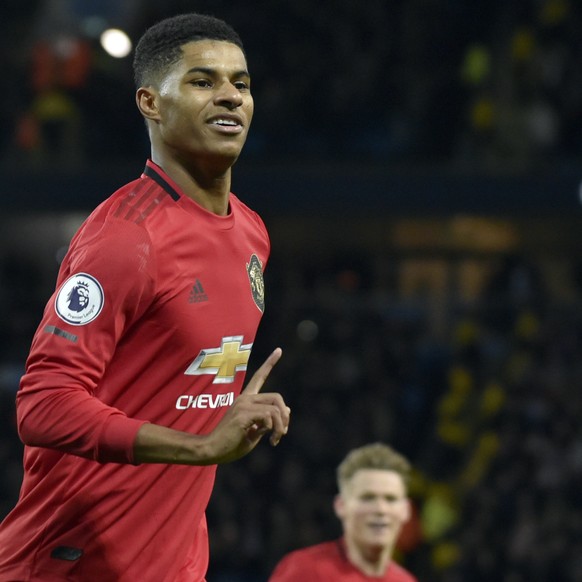 Manchester United's Marcus Rashford celebrates after scoring his side's opening goal from the penalty spot during the English Premier League soccer match between Manchester City and Manchest ...