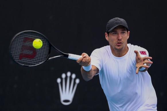 epa09690410 Dusan Lajovic of Serbia in action against Marton Fucsovics of Hungary during their first round match at the Australian Open Grand Slam tennis tournament in Melbourne, Australia, 17 January ...