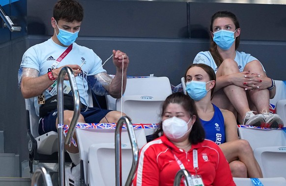 210803 -- TOKYO, Aug. 3, 2021 -- Thomas Daley L of Great Britain sits with his knitting prior to the men s 3m springboard final of diving at the Tokyo 2020 Olympic Games, Olympische Spiele, Olympia, O ...