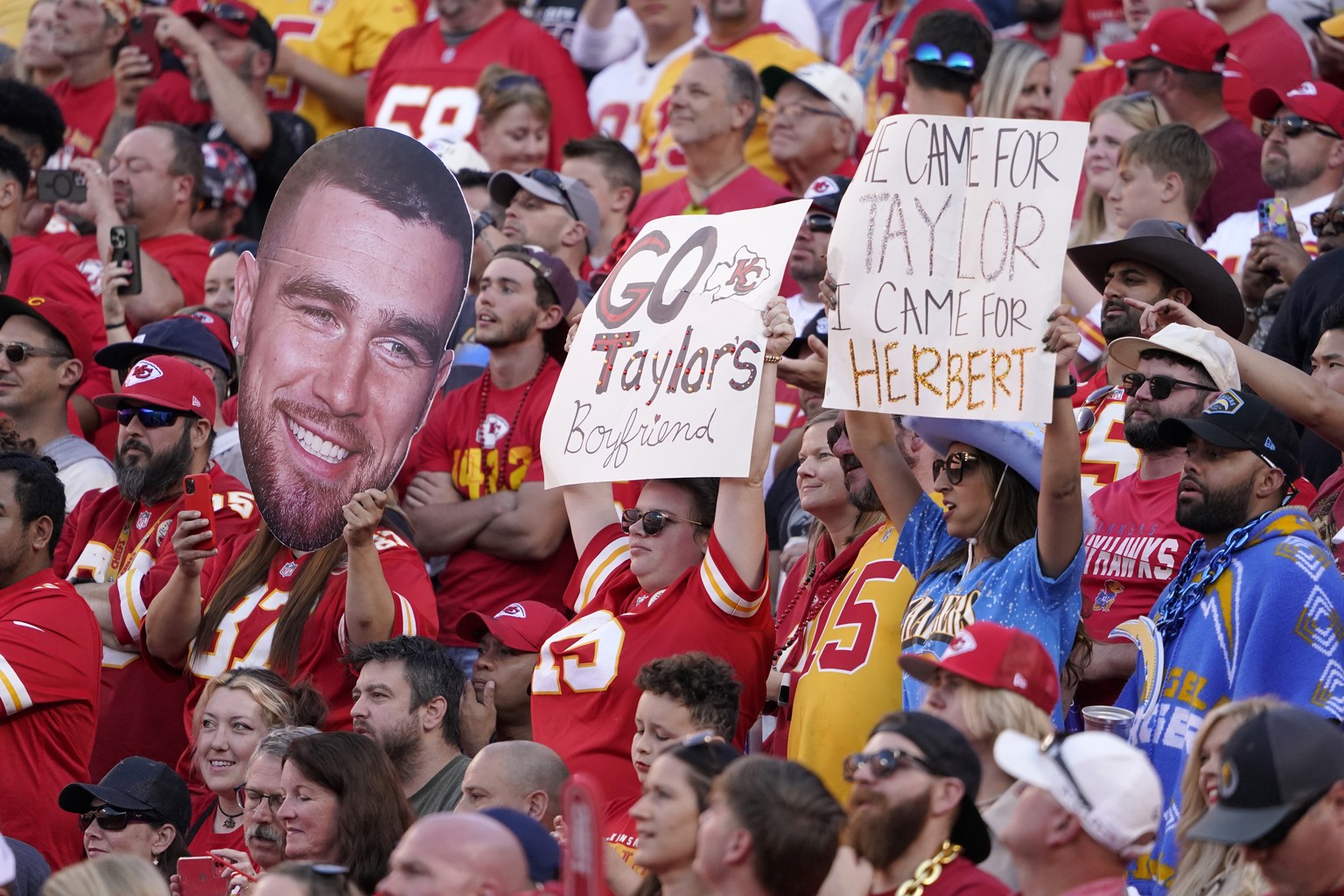 Fans hold sighs referring to Kansas City Chiefs tight end Travis Kelce (87) and Taylor Swift during the first half of an NFL football game between the Kansas City Chiefs and the Los Angeles Chargers S ...