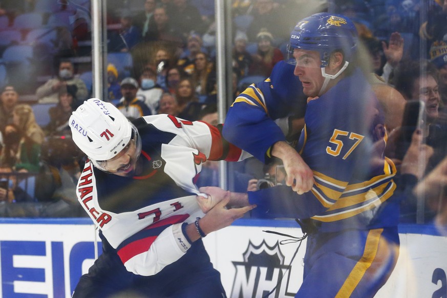 New Jersey Devils defenseman Jonas Siegenthaler (71) and Buffalo Sabres left wing Brett Murray (57) fight during the first period of an NHL hockey game, Wednesday, Dec. 29, 2021, in Buffalo, N.Y. (AP  ...