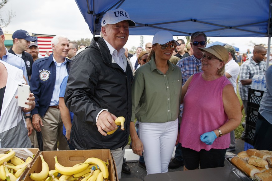 President Donald Trump and first lady Melania Trump, talk and hand out food to people impacted by Hurricane Irma at Naples Estates, Thursday, Sept. 14, 2017, in Naples, Fla. (AP Photo/Evan Vucci)