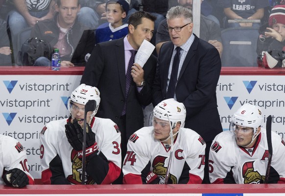 Ottawa Senators head coach Guy Boucher, left, speaks with assistant coach Marc Crawford during the third period of a preseason NHL hockey game in Halifax, Nova Scotia, Monday, Sept. 26, 2016. (Darren  ...