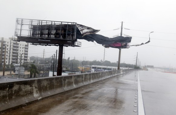 A billboard is ripped apart by high winds along Interstate 95 Northbound as Hurricane Irma passes by, Sunday, Sept. 10, 2017, in Miami. (AP Photo/Wilfredo Lee)