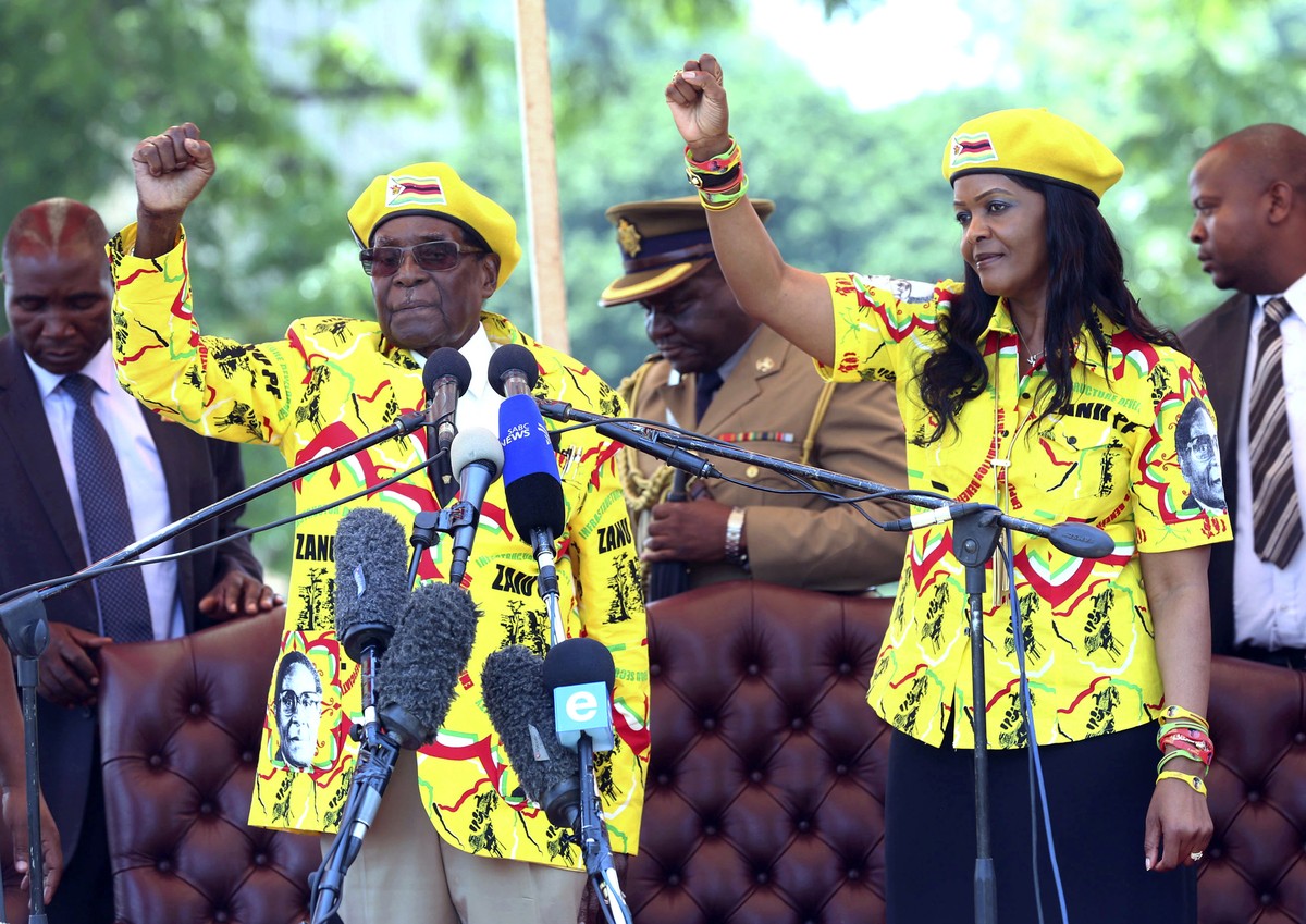FILE - In this Nov. 8, 2017, file photo, Zimbabwe's President Robert Mugabe, left, and his wife Grace Mugabe chant the party's slogan during a solidarity rally in Harare, Zimbabwe. Zimbabwe& ...