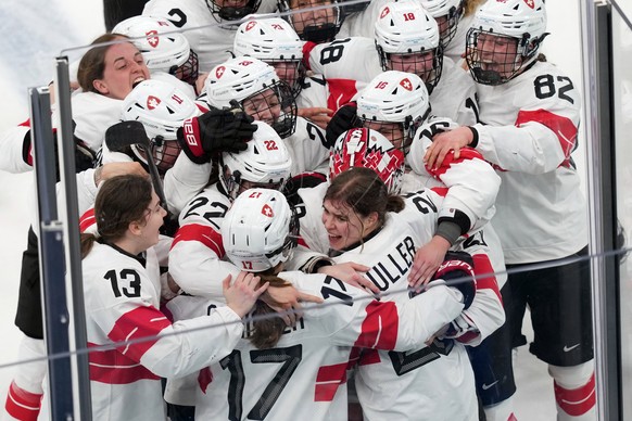 KEYPIX - Team Switzerland players celebrate after Alina Muller (25) scored the winning goal in overtime to beat Sweden in the women's ice hockey bronze medal game at the 2026 Winter Olympics, in  ...