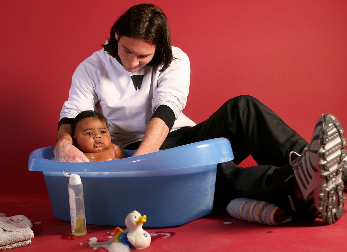 20-year-old soccer star Lionel Messi helps to bathe Lamine Yamal, who was merely six months old at the time, during a photo session in Sept. 2007 in the dressing room of the Camp Nou stadium in Barcel ...