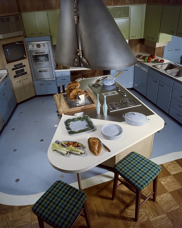 UNITED STATES - AUGUST 01 1958: 12 new idea kitchens: Powder Blue cabinets and floor surround a Modernist center island cooktop and barbecue in this model kitchen by designers Ralph &amp; Jane Bonnell ...