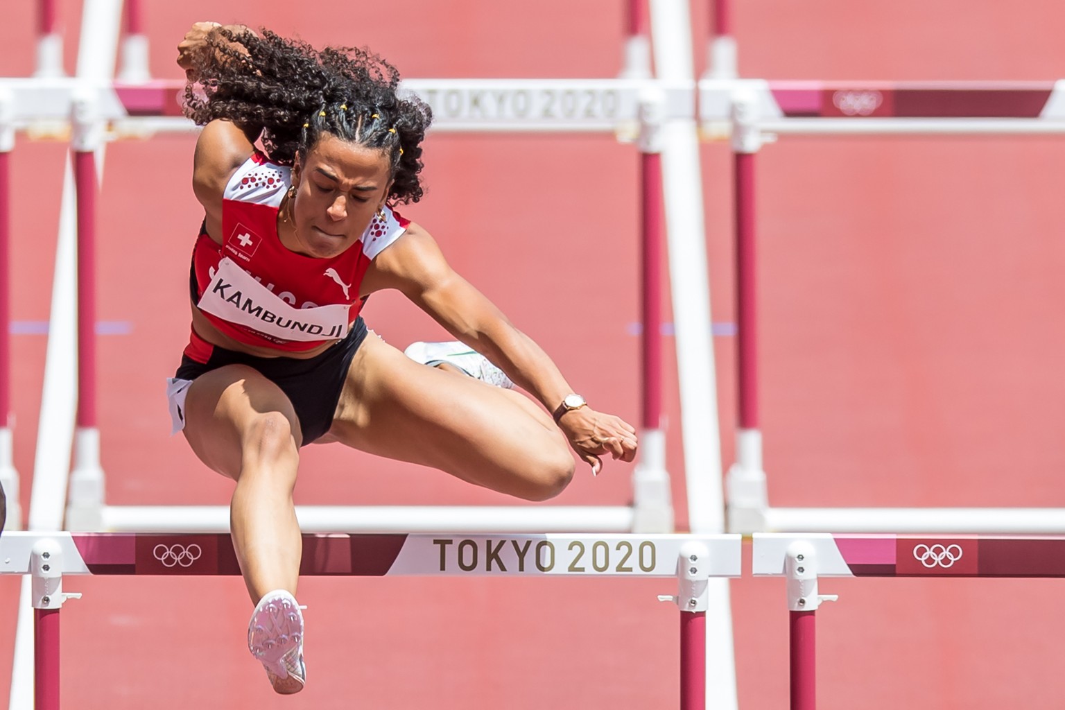 Ditaji Kambundji of Switzerland competes in the first round of the women�s 100 m hurdles at the 2020 Tokyo Summer Olympics Games in Tokyo, Japan, on Saturday, July 31, 2021 (KEYSTONE/ATHLETIX.CH/Ulf S ...