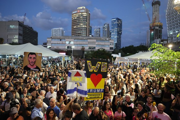 epa12442262 People celebrate after a peace deal is announced at Hostages Square in Tel Aviv, Israel, 09 October 2025. US President Donald Trump announced that Israel and Hamas have agreed to the first ...