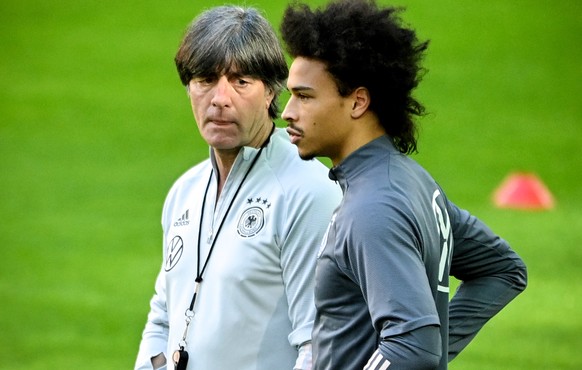 epa09106998 German national soccer team&#039;s head coach Joachim Loew (L) gives instructions to Leroy Sane (R) during their team&#039;s training session in Duesseldorf, Germany, 30 March 2021. German ...