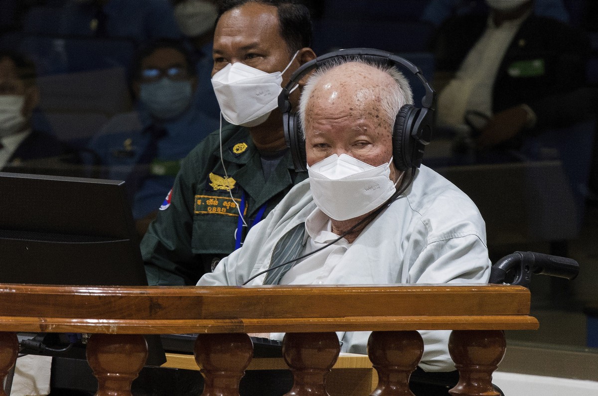 In this photo released by the Extraordinary Chambers in the Courts of Cambodia, Khieu Samphan, right, the former head of state for the Khmer Rouge, sits in a courtroom during a hearing at the U.N.-bac ...