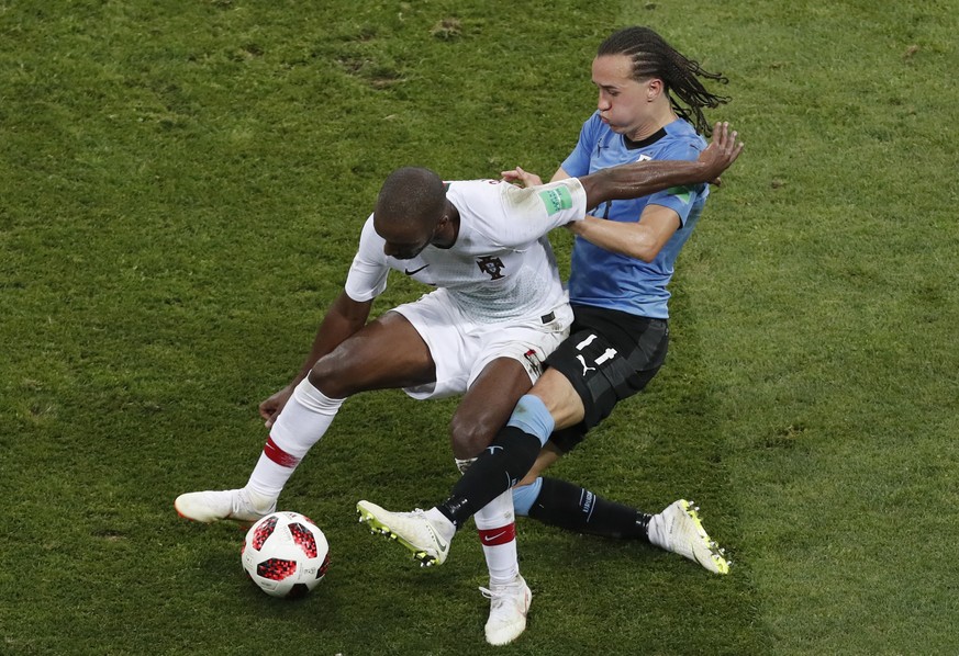 Portugal&#039;s William, left, is challenged b Uruguay&#039;s Diego Laxalt during the round of 16 match between Uruguay and Portugal at the 2018 soccer World Cup at the Fisht Stadium in Sochi, Russia, ...