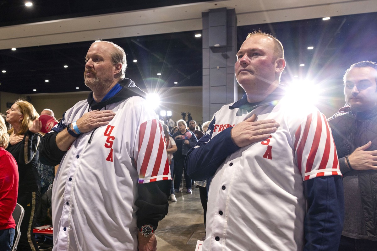 epa11195312 Supporters of former US President Donald Trump stand for the National Anthem ahead of Trump's Super Tuesday campaign rally in Richmond, Virginia, USA, 02 March 2024. Trump is running  ...