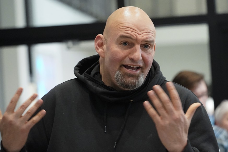 In this photo made on Friday, March 4, 2022, Pennsylvania Lt. Gov. John Fetterman visits with people attending a Democratic Party event for candidates to meet and collect signatures for ballot petitio ...