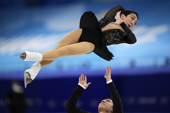 Sui Wenjing and Han Cong, of China, compete in the pairs short program during the figure skating competition at the 2022 Winter Olympics, Friday, Feb. 18, 2022, in Beijing. (AP Photo/Bernat Armangue)
 ...