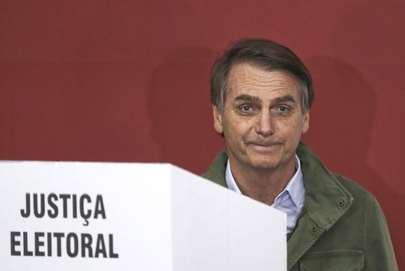 epa07126559 Far-right candidate of the Social Liberal Party (PSL) Jair Bolsonaro (R) votes at a polling station in Rio de Janeiro, Brazil, 28 October 2018. Brazilians are called to vote in the second  ...