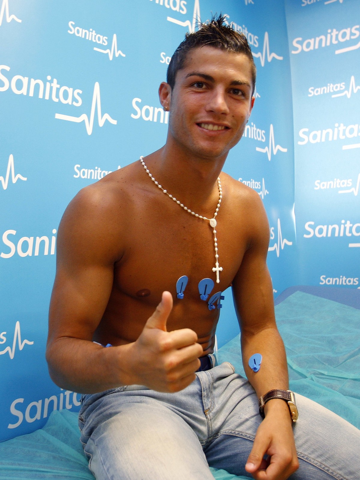 In this photo released by Real Madrid, Portuguese soccer player Cristiano Ronaldo gives the thumbs up during a medical examination at a clinic in Madrid, Monday July 6, 2009. Madrid's medical sta ...