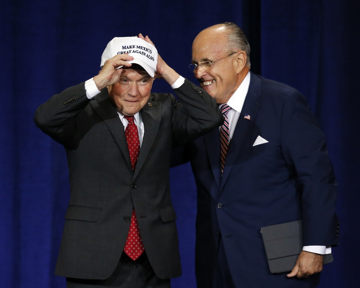 Former mayor of New York CIty Rudy Giuliani, right, give U.S. Sen. Jeff Sessions, R-AL., a "Make Mexico Great Again Also" hat prior to Republican presidential candidate Donald Trump's s ...