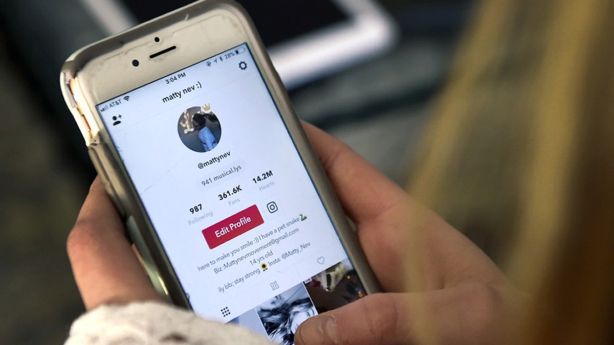 FILE - In this Feb. 28, 2018 photo, Matty Nev Luby holds her phone and logs into the lip-sync smartphone app Musical.ly, in Wethersfield, Conn. The operator of the video-sharing app popular with teena ...