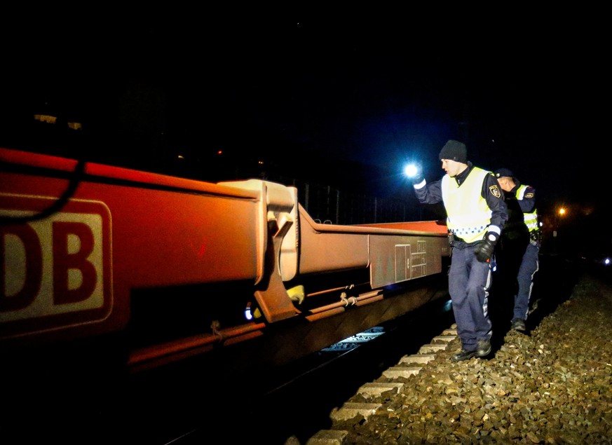 Police officers check a freight train for migrants during a routine check on a train station in Steinach am Brenner December 16, 2016. Picture taken December 16, 2016. REUTERS/Dominic Ebenbichler