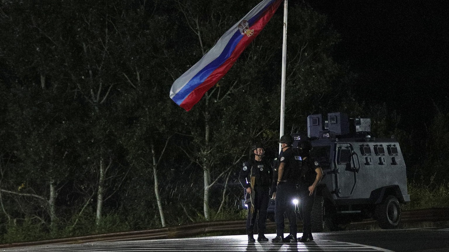 Kosovo police officers guard road near the village of Banjska, northern Kosovo, Sunday, Sept. 24, 2023. At least 30 gunmen killed a Kosovar Albanian police officer then stormed an Orthodox monastery i ...