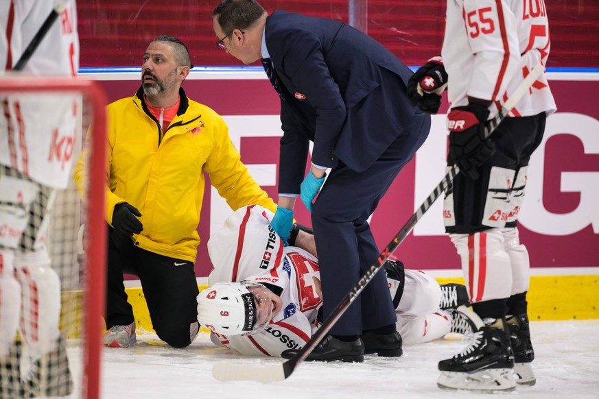 230504 Lian Bichsel of Switzerland in pain after getting injured during the Czech Hockey Games game between Sweden and Switzerland on May 4, 2023 in Gothenburg. Photo: Joel Marklund / BILDBYRAN / kod  ...