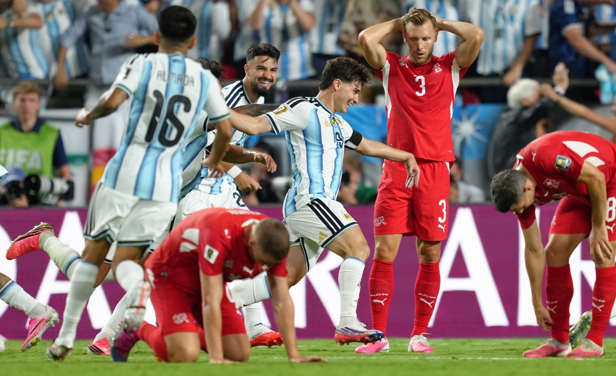 Argentina's Julian Alvarez (9) celebrates after scoring his side's second goal as Switzerland's Silvan Widmer (3) reacts, during the World Cup quarterfinal soccer match between Argentin ...