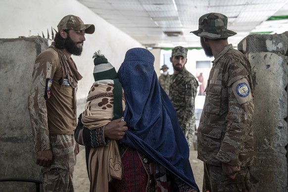 An Afghan refugee woman returns to Afghanistan through the Pakistan-Afghanistan border in Torkham, Afghanistan, Friday, Nov. 3, 2023. Many Afghan refugees arrived at the Torkham border to return home  ...