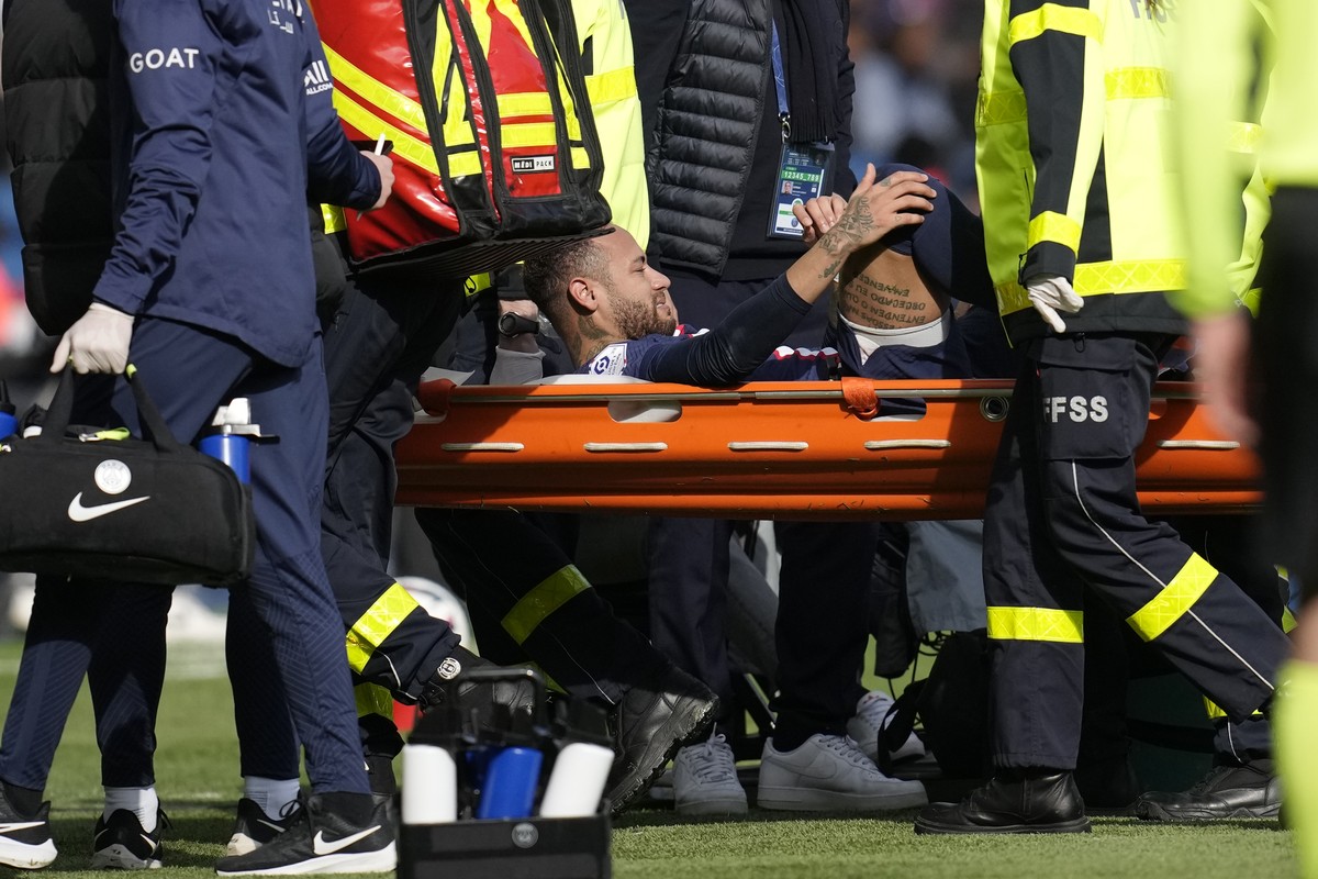 PSG's Neymar is carried off the field on a stretcher after after injuring during the French League One soccer match between Paris Saint-Germain and Lille at the Parc des Princes stadium, in Paris ...